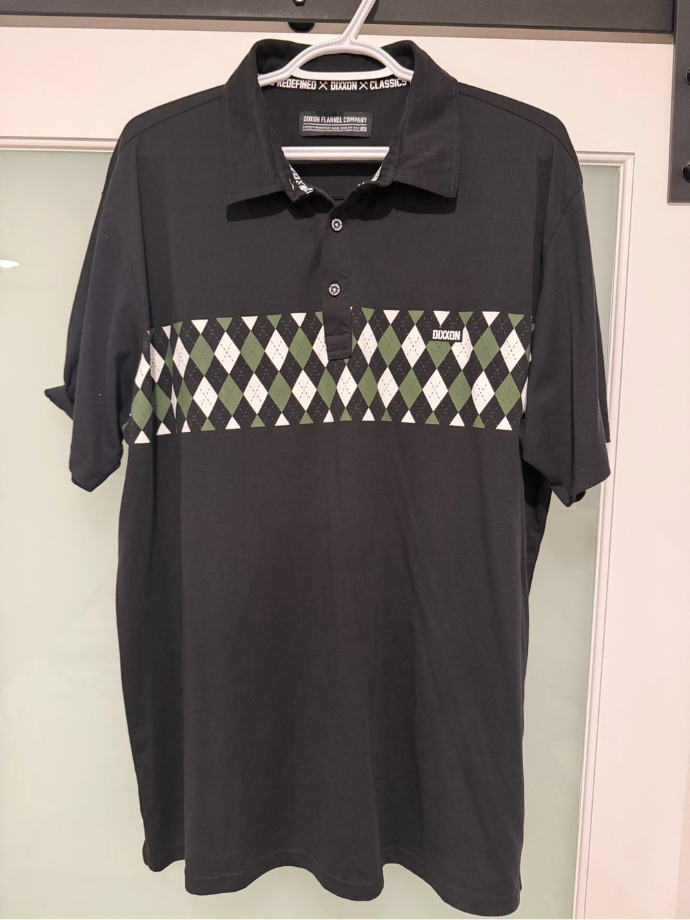 DIXXON Black Polo with Green and White Argyle Chest Band